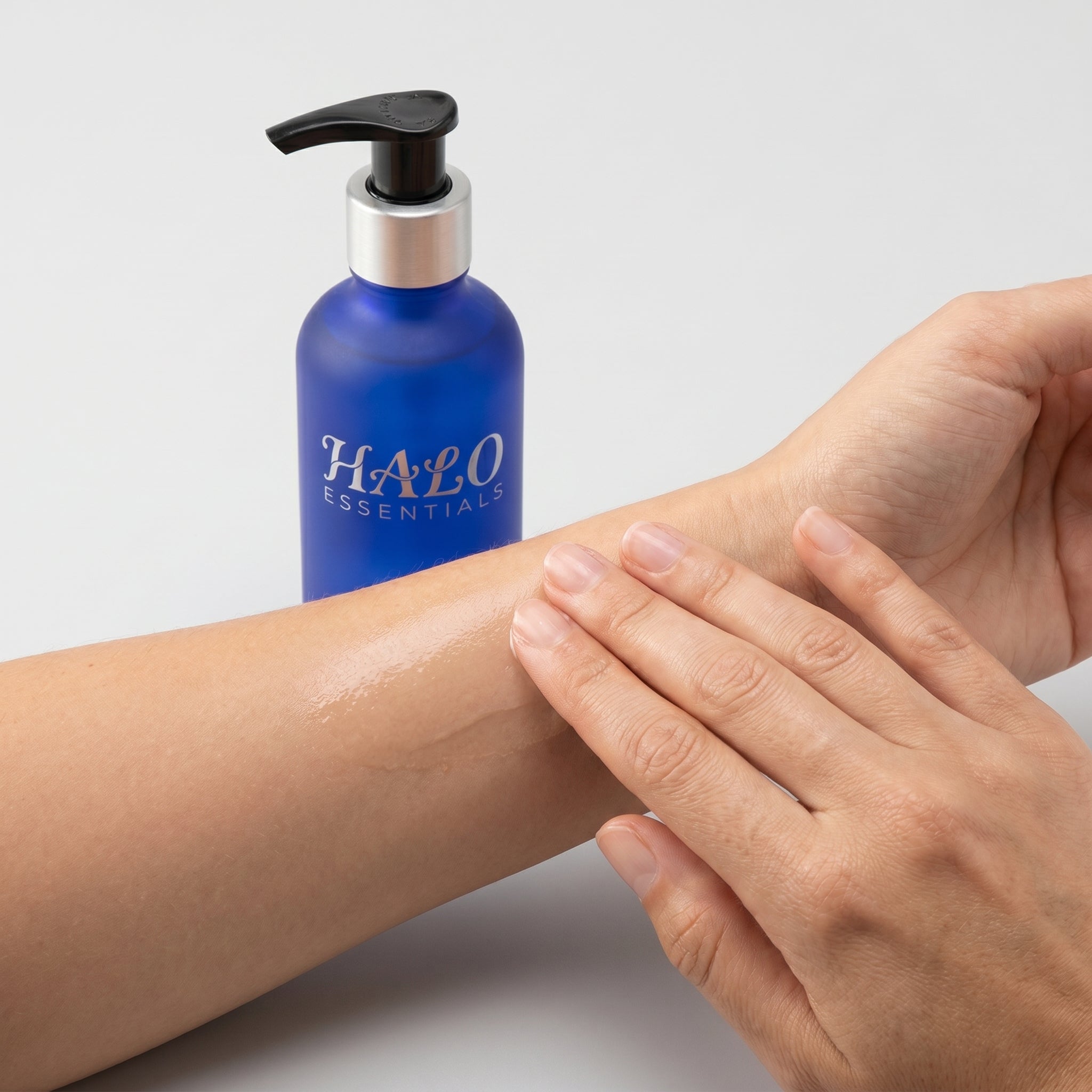 Halo Essentials body oil absorbing into skin